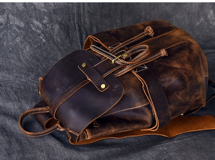 Interior canvas lining of dark gothic leather backpack showing inner zipper pockets and compartments
