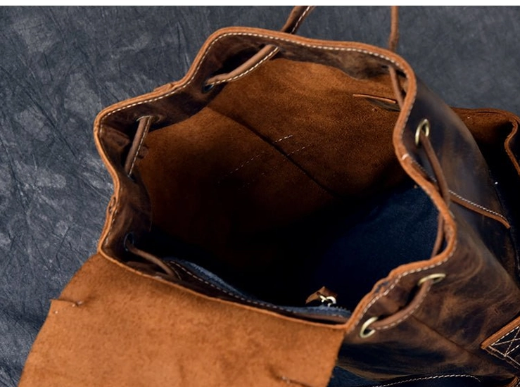 Vintage brown leather gothic backpack styled with alternative fashion accessories and dark aesthetic