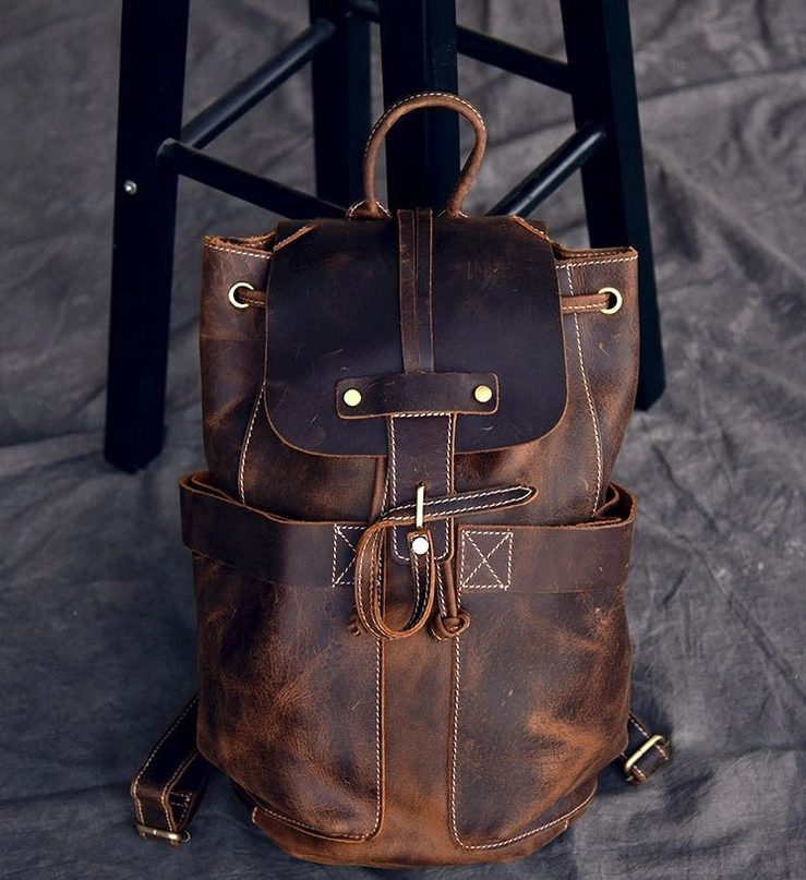 Weathered brown cow leather gothic travel backpack with contrast top stitching and flap closure