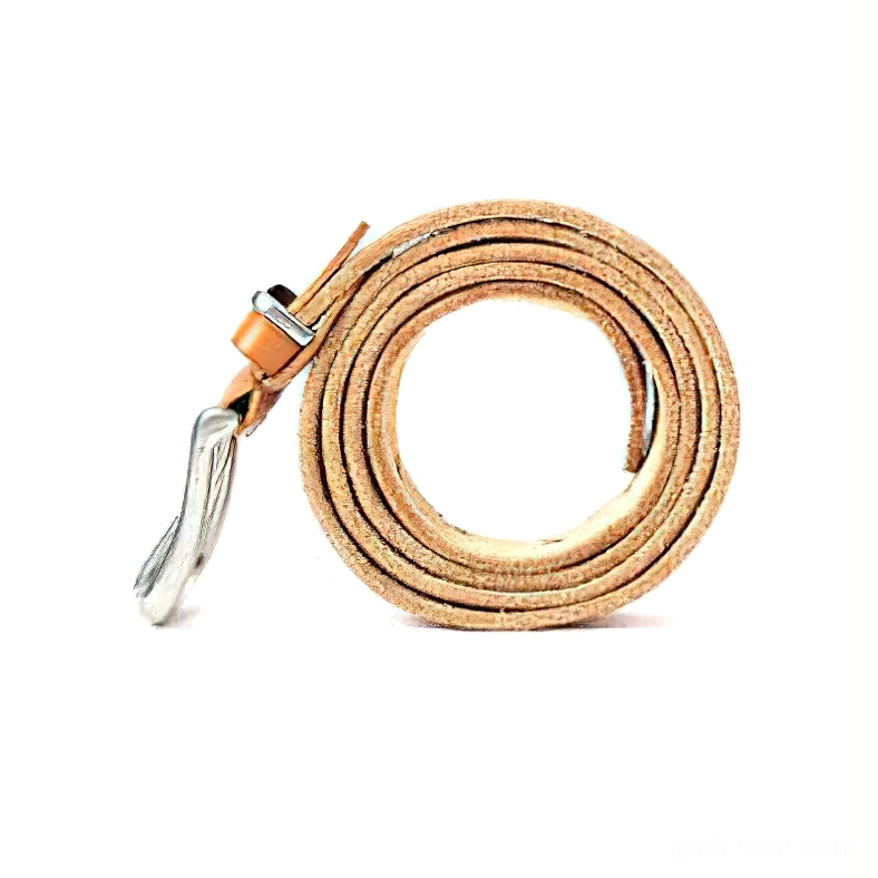 Slim tan leather gothic belt fully coiled overhead flat lay with silver pin buckle accent