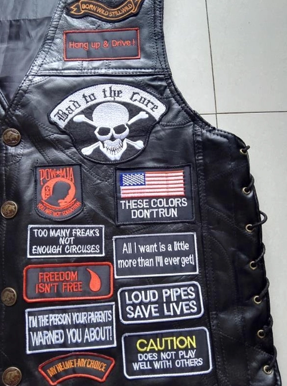 Gothic black leather biker vest texture and construction close-up professional product shot