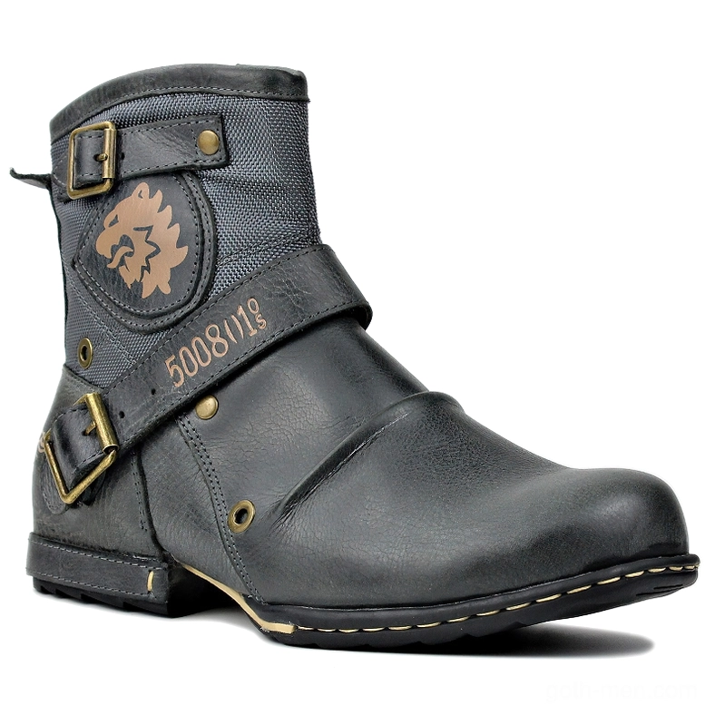 Gothic leather ankle boots with brass buckles and lion emblem, front three-quarter view on white background