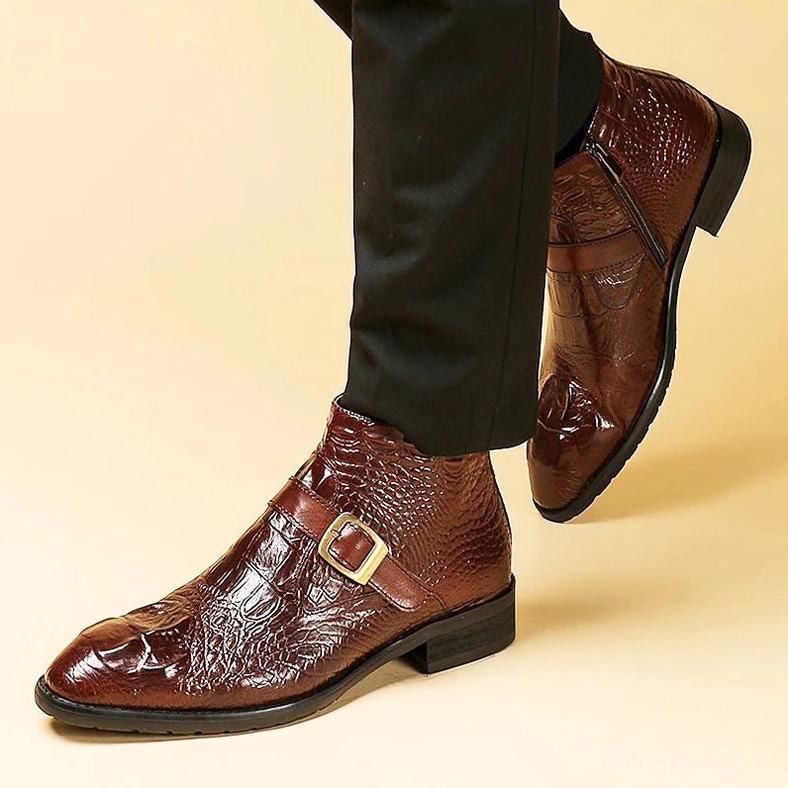 Man wearing gothic crocodile embossed leather ankle boots on model, brown color oblique view