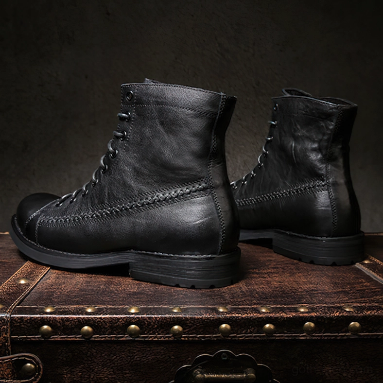 Black vintage gothic lace-up boots with thick rubber tractor sole on suitcase