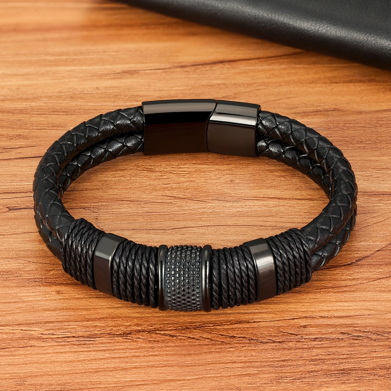 All-black braided leather gothic bracelet with matte stainless steel hardware from overhead perspective