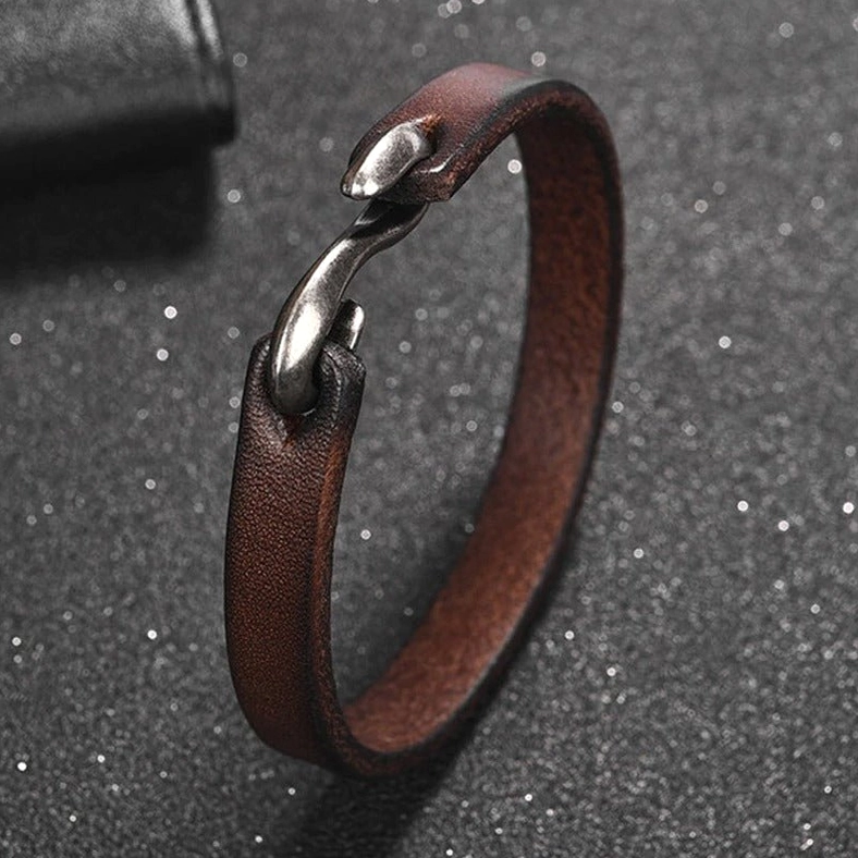 Distressed brown leather gothic cuff bracelet detail shot showing authentic leather grain and hook fastening mechanism