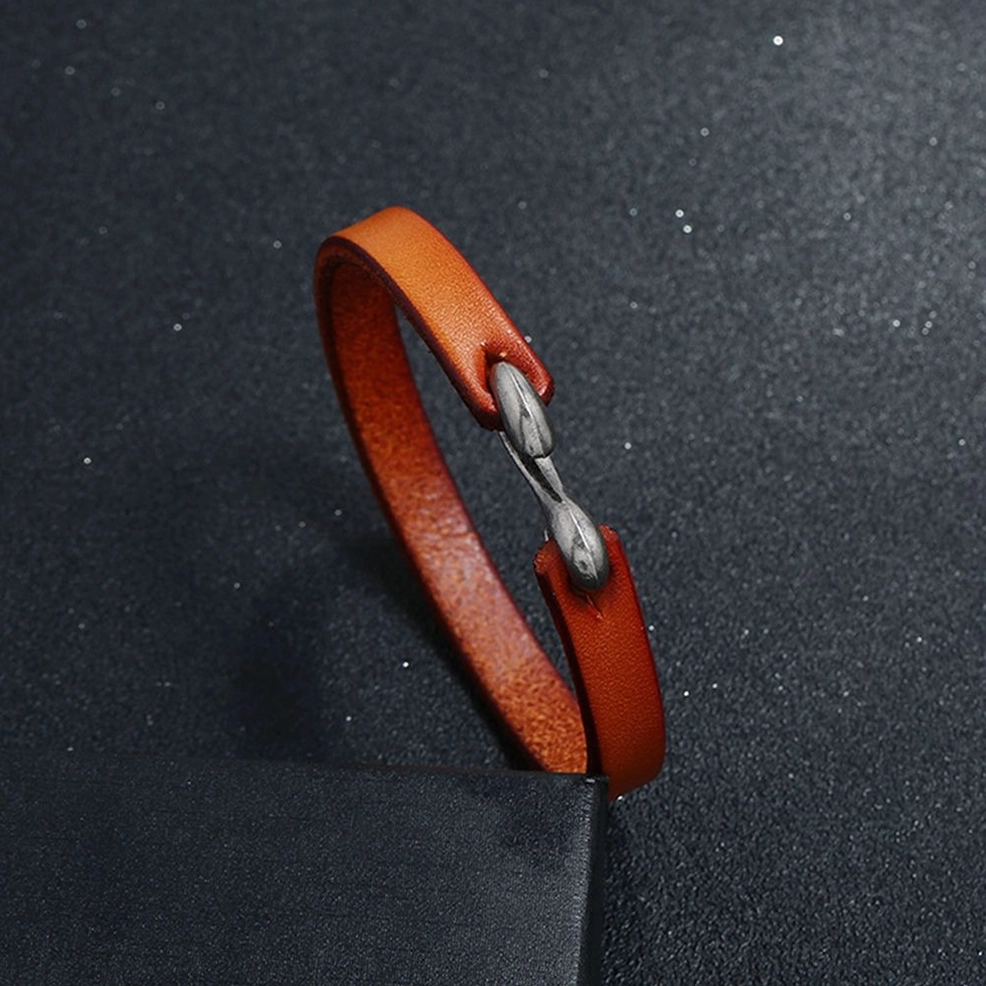 genuine leather gothic cuff bracelet closeup - antique silver hook clasp and authentic leather texture