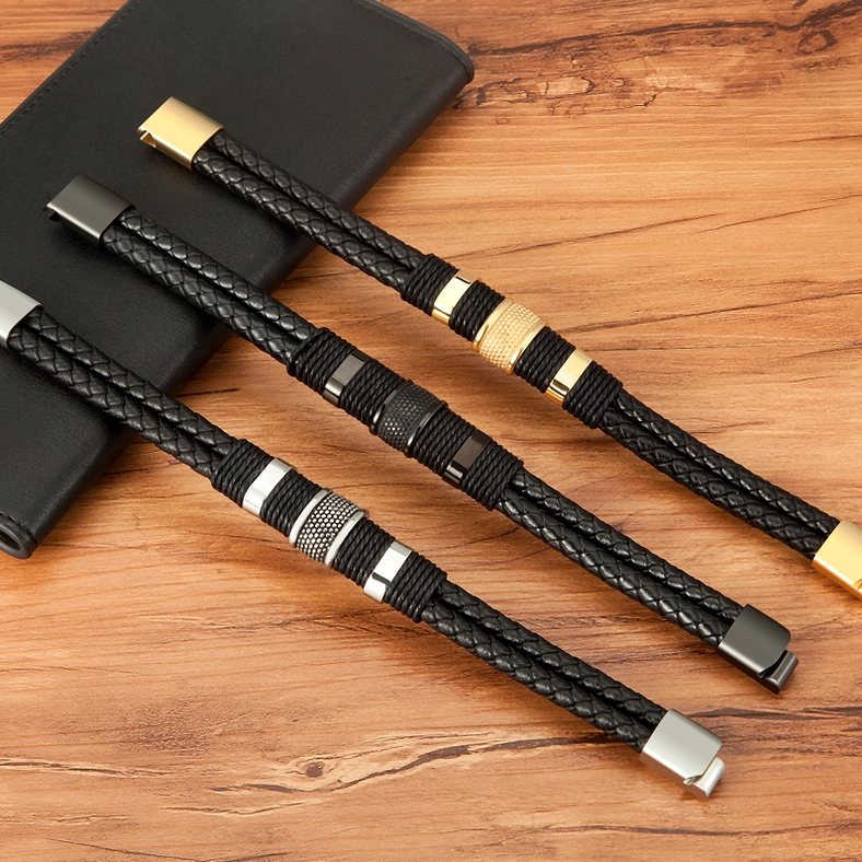 Flat lay collection of three gothic leather bracelets showing black, gold-black, and mixed hardware color schemes