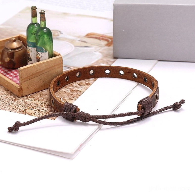 Flat lay side view of adjustable leather cuff bracelet with punch holes and dark distressed finish