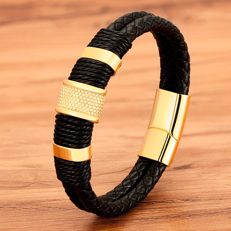 Gold-black gothic leather bracelet with textured decorative metal rings and braided leather construction