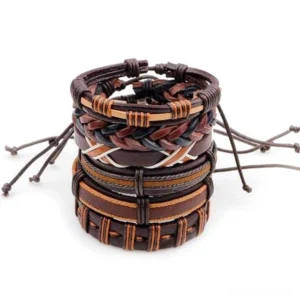 Top-down view of 6-piece gothic brown leather bracelet set with braided rope wristbands stacked together on white background