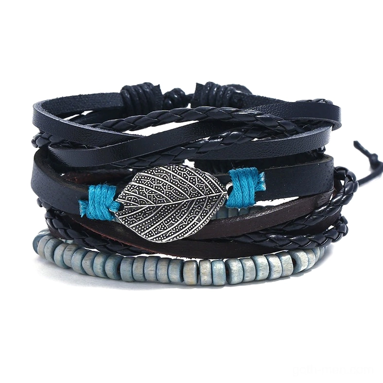 Gothic leather bracelet set flat lay featuring multi-layered bangles with antique silver feather charm, natural wooden beads, and blue cord accents