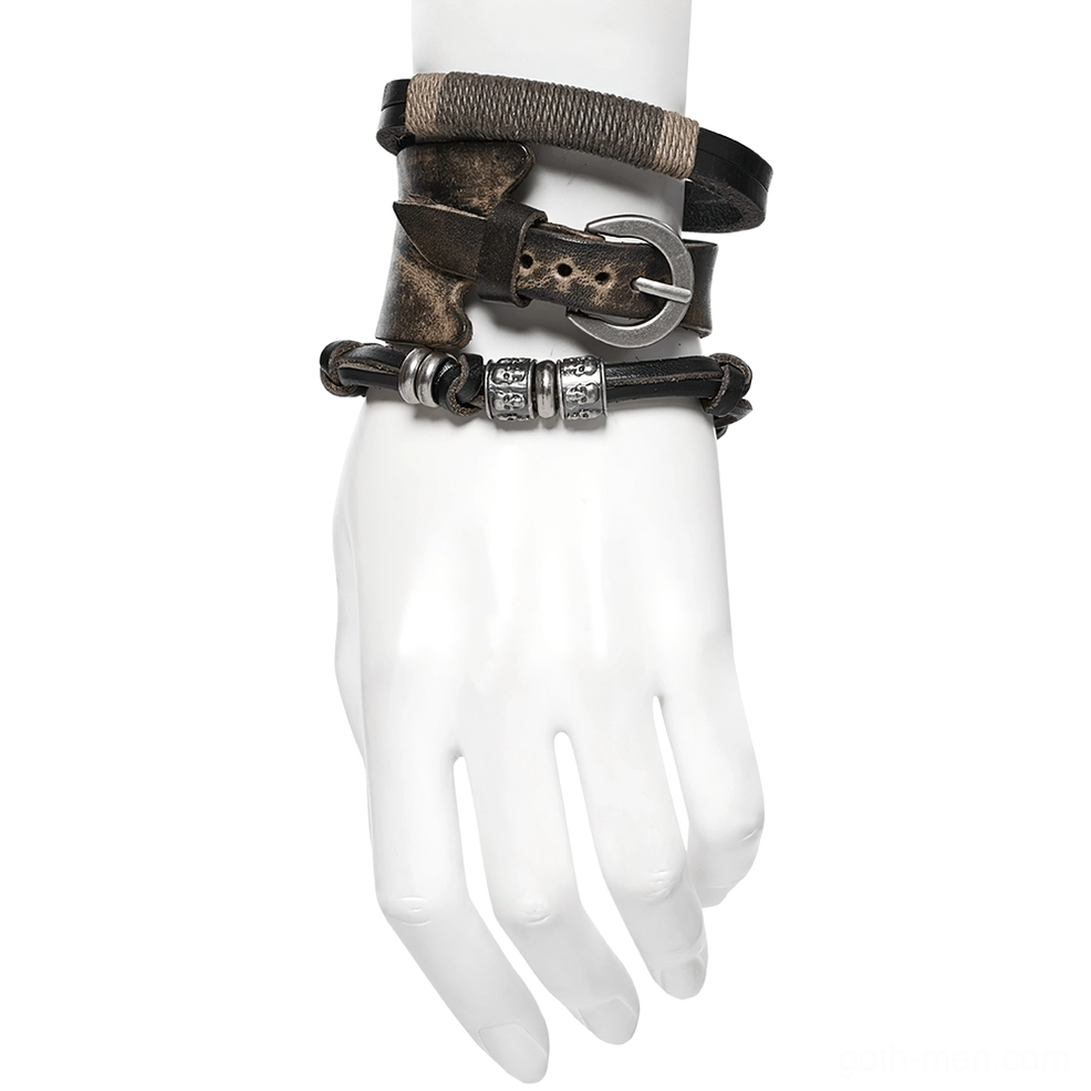 Mannequin hand modeling stacked gothic punk leather bracelets, layered cuff and belt strap style with vintage cowhide and antique metal accents
