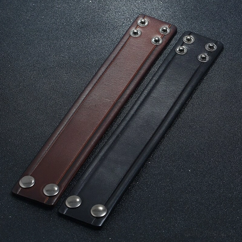 Unassembled black and brown leather bracelet straps with metal snap fittings on both ends
