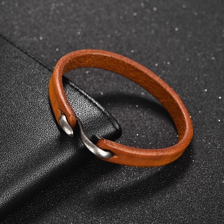 Overhead view of honey tan leather gothic bracelet with vintage boat hook metal clasp, matte leather finish