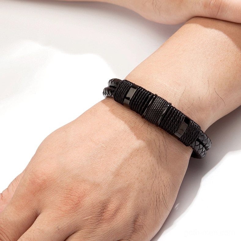 Close-up side view of black braided leather gothic bracelet on male wrist showing magnetic clasp fit