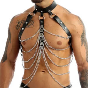 Black PU leather men's chest harness with silver chains and metal rivets - front close-up view on tattooed male model