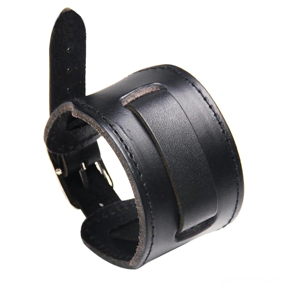 Black genuine leather gothic wristband cuff with metal buckle fastener and reinforced stitched seams, front view on dark background