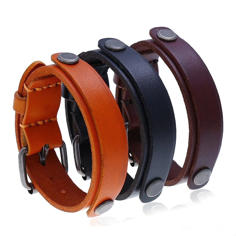 Three-piece set of genuine leather gothic cuff bracelets in black, brown, and burnt orange with antique silver rivets and buckles, displayed on white background