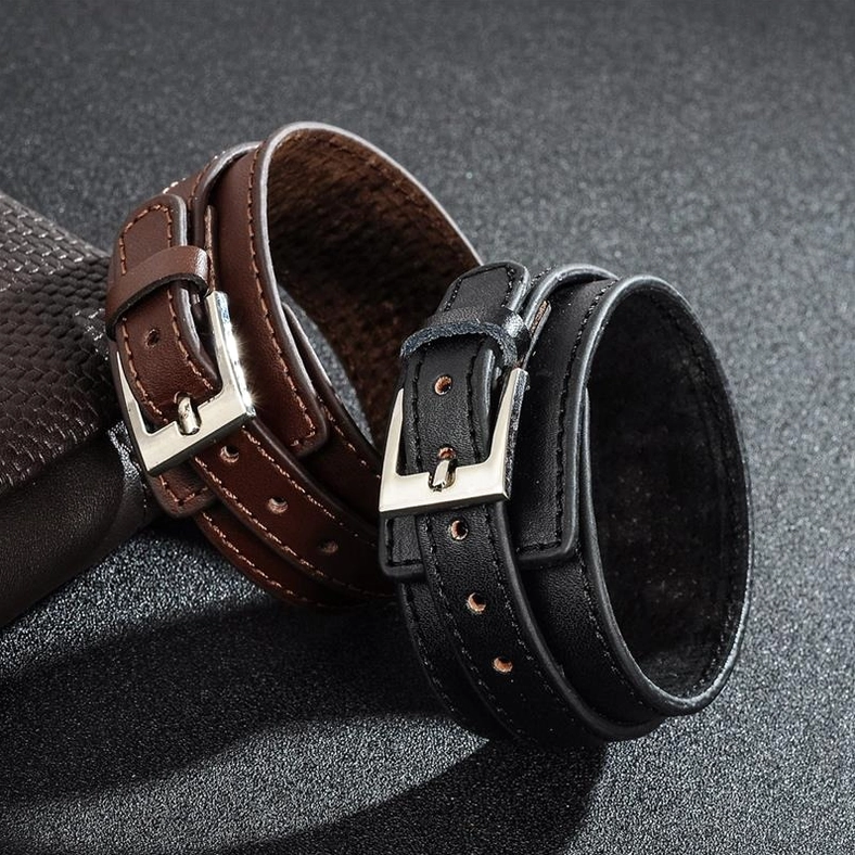 Black and brown gothic leather cuff bracelets displayed together with silver metal buckles, side view comparison