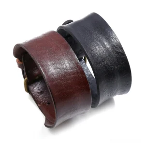 Wide gothic leather cuff bracelet in brown and black, adjustable punk style wristband with bronze clasp, flat lay overview