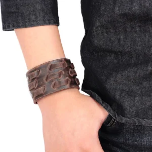 Men wearing distressed leather gothic cuff bracelet on wrist with denim, lifestyle styling