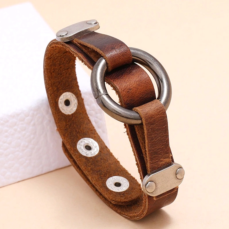 Three-quarter closeup gothic leather cuff bracelet on display showing brown distressed texture, dark metal alloy ring, and rivet hole pattern