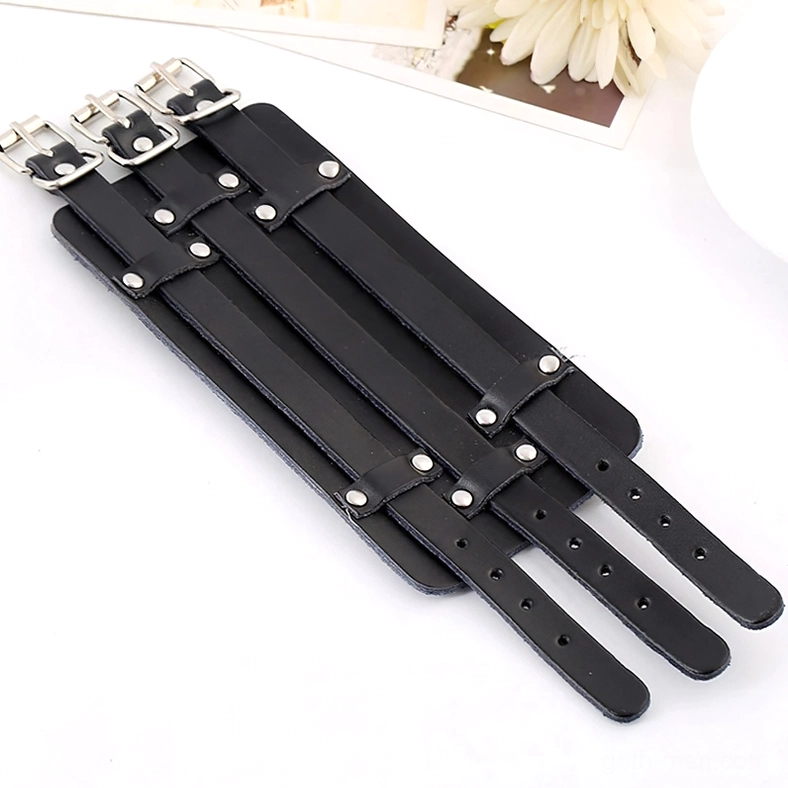 Disassembled gothic leather cuff bracelet components showing adjustable strap units with silver metal buckles, flat lay view