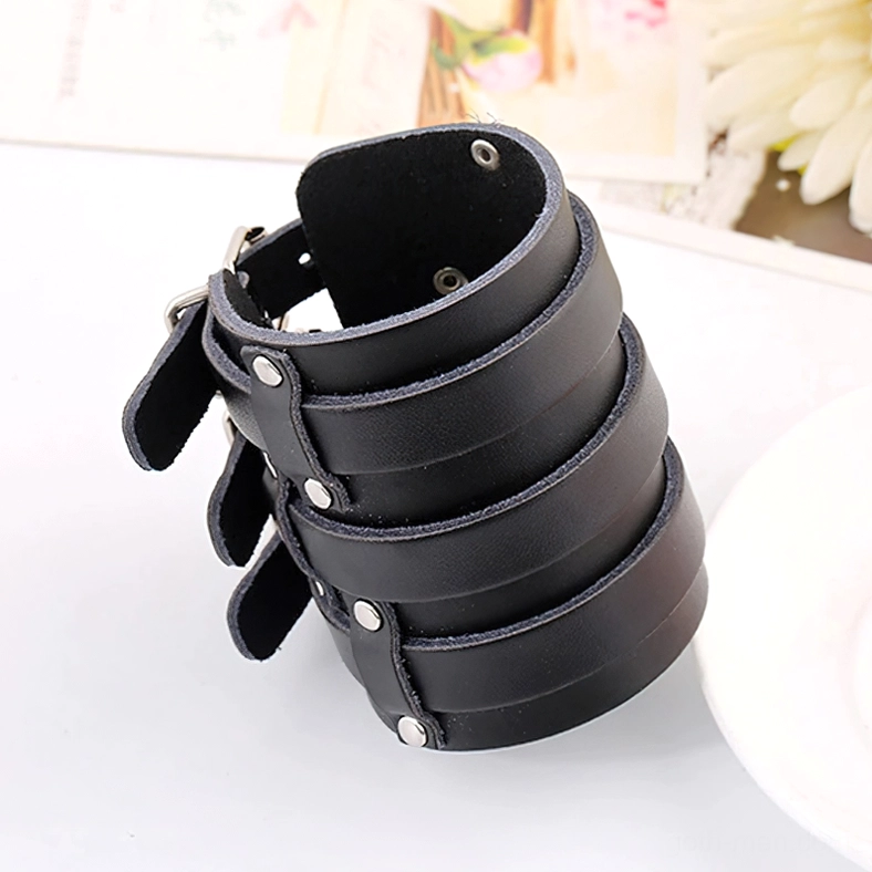 Multi-strap leather gothic bracelet back view with metal stud fasteners and three parallel strap design, flatlay styling