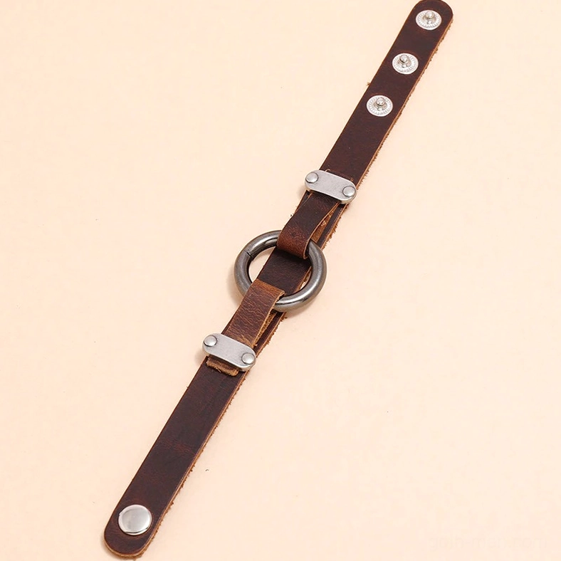 Unfolded vintage gothic leather bracelet strap showing full length, central alloy ring, adjustable snap holes, and rivet detail work