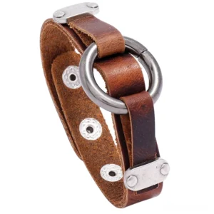 Vintage gothic leather cuff bracelet with silver alloy ring and rivets, closeup side view showing distressed brown leather and metal details