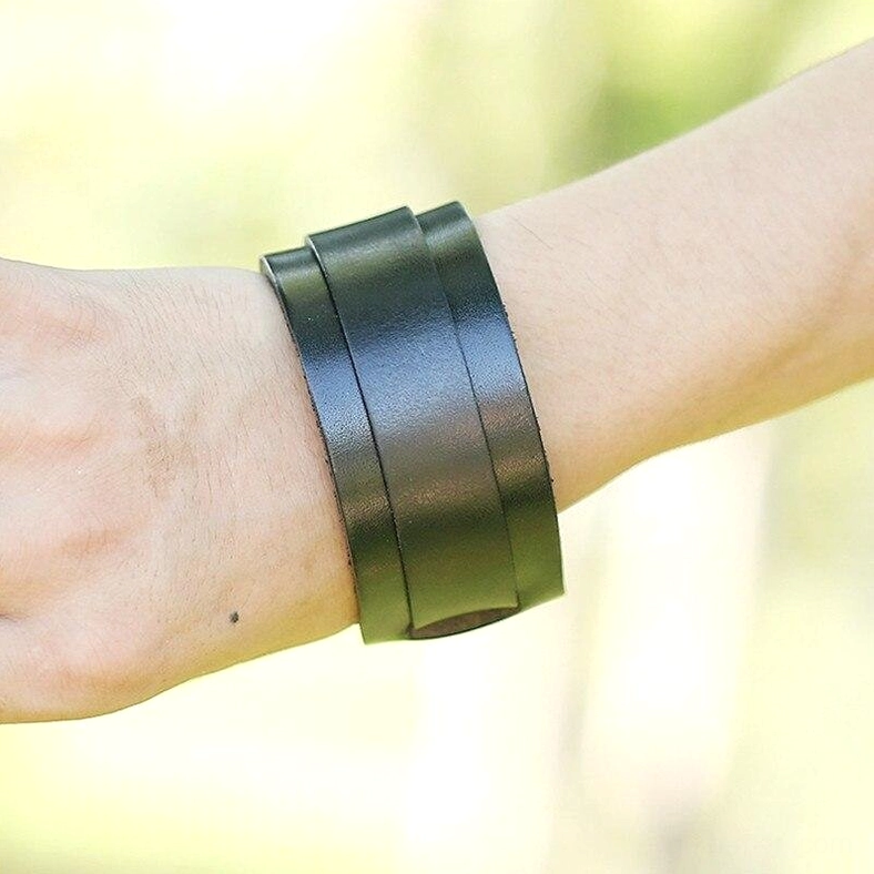 double-wide black leather gothic bracelet worn on wrist outdoor lifestyle photography