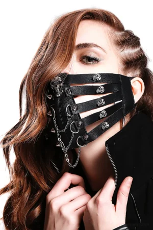 Steampunk gothic black leather face mask with metal skull studs and chains worn by female model, side profile view