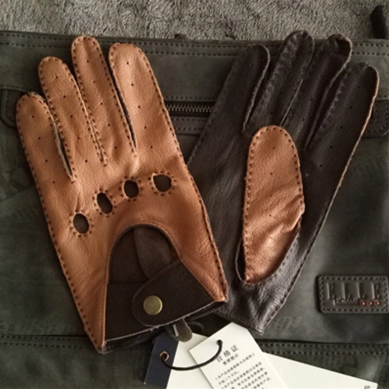 Tan and dark brown gothic leather gloves with perforated vents and snap wrist strap displayed on leather accessories