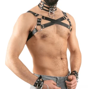 Black gothic leather chest harness with cross shoulder straps and metal D-rings, left front view on male model