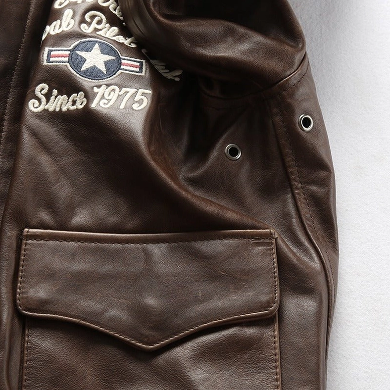 Full back view of gothic biker jacket displaying embroidered flight graphic and leather texture