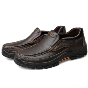 Pair of brown gothic slip-on leather loafers with contrast stitching and pebbled leather texture, front angled view
