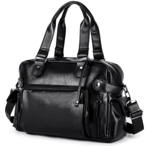 Gothic black leather messenger bag three-quarter front view with dual top handles and multiple zipper pockets