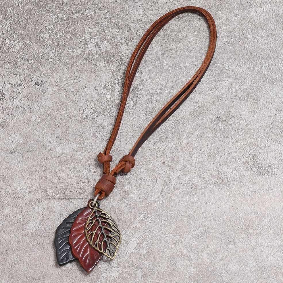 Orange and black layered leather leaf pendant with hollow bronze alloy leaf design on genuine cowhide gothic necklace - close-up