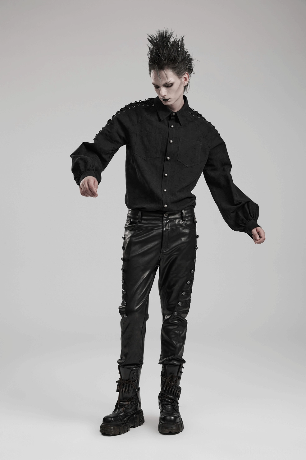 Alternative view of black studded gothic leather pants front profile emphasizing slim fitted cut and side button details