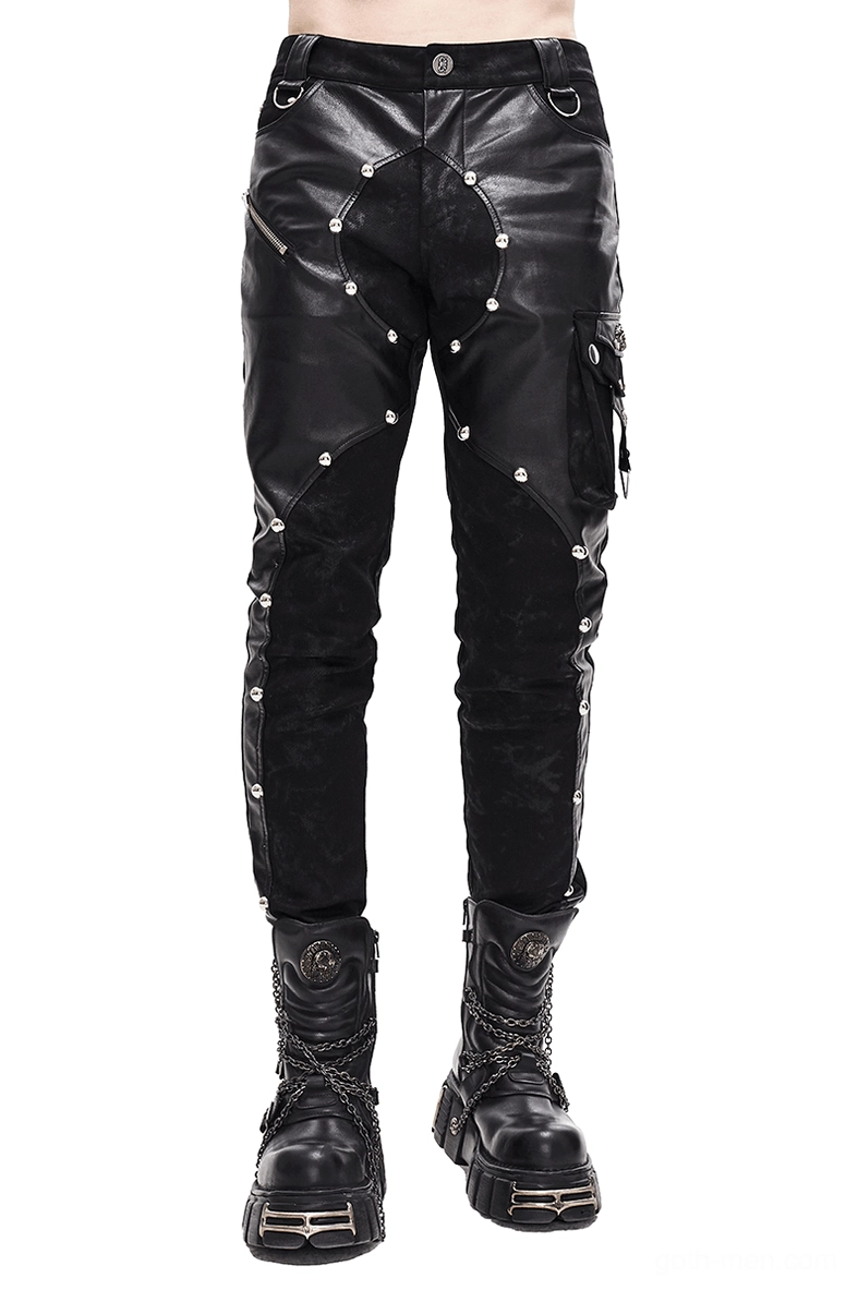 Black gothic leather rivet pants front view on male model - asymmetric faux leather spliced design with metal rivets