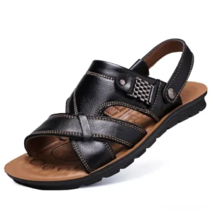 Black leather gothic sandals with cross-strap design and metal buckle detail, side profile view