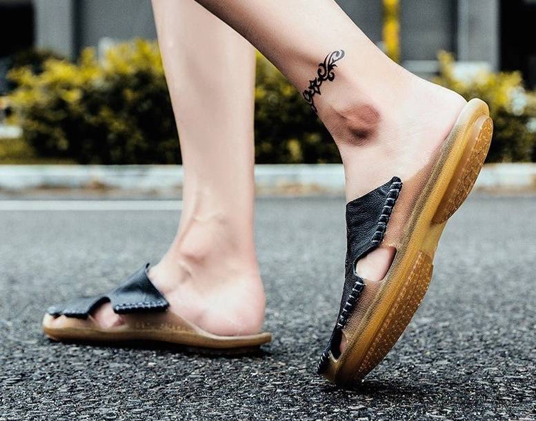 Gothic split leather sandals detail shot showing embossed surface texture and hand-stitched construction