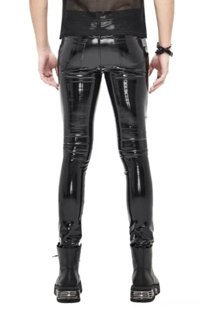 Black patent leather cyberpunk pants rear view on male model wearing sheer top and wrist accessories with platform boots