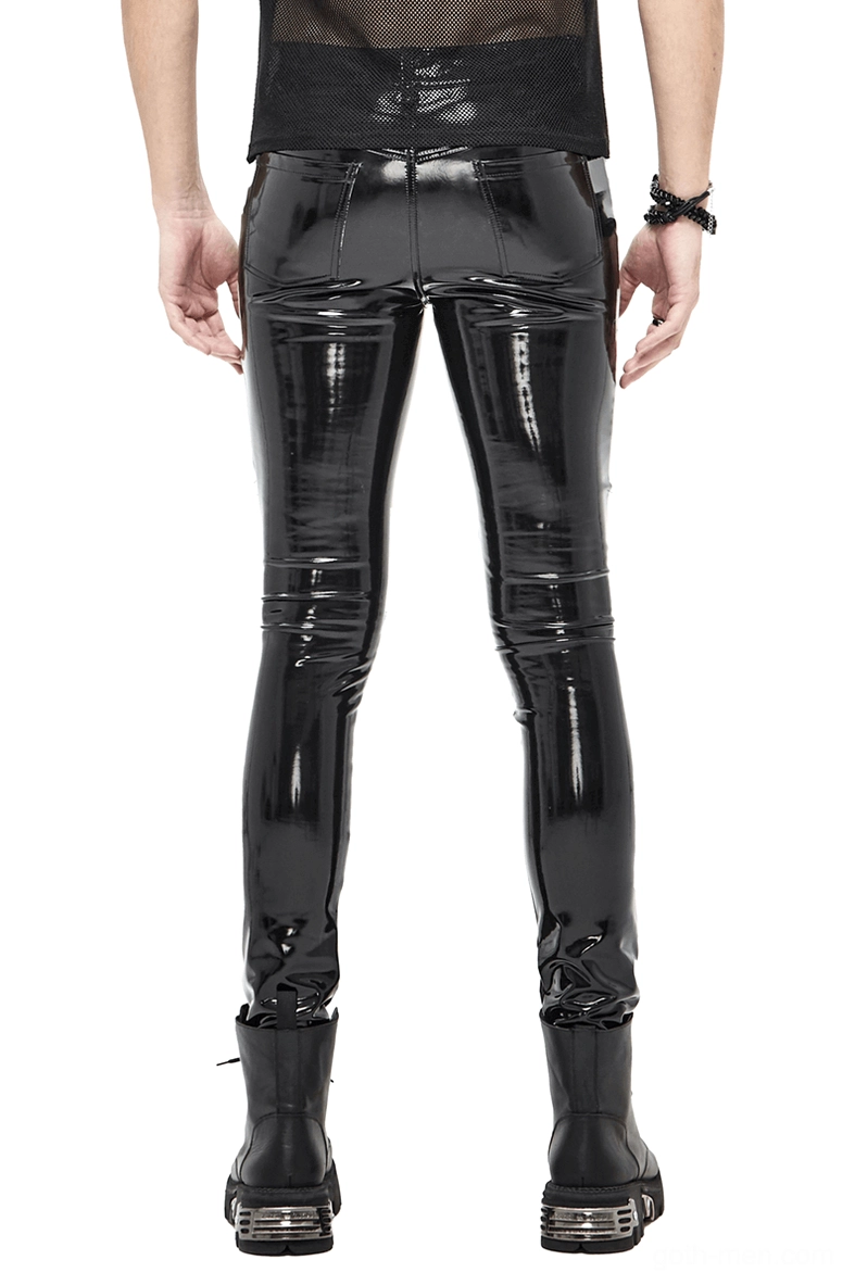 Black patent leather cyberpunk pants rear view on male model wearing sheer top and wrist accessories with platform boots