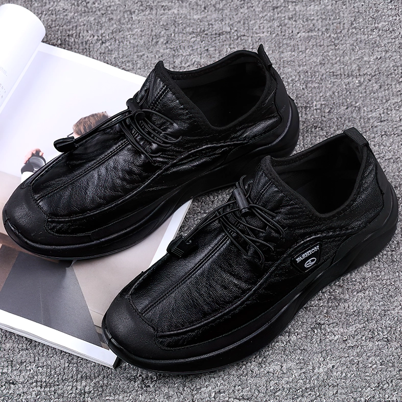 Black leather alternative sneaker with side branded patch and smooth upper, flat lay display