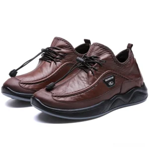 Brown leather alternative gothic sneaker with structured silhouette, three-quarter front angle