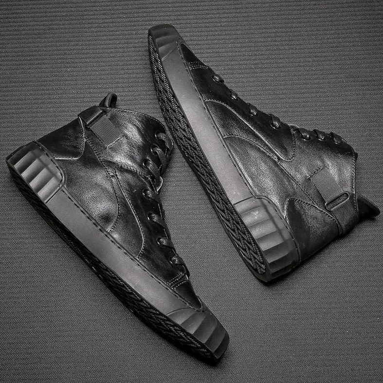 Overhead flat lay of black leather gothic sneakers showing sole pattern and heel strap buckle detail