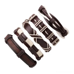 Flat lay display of five gothic leather wristbands in brown and white tones, showcasing varied braided weave designs and rock aesthetic styles