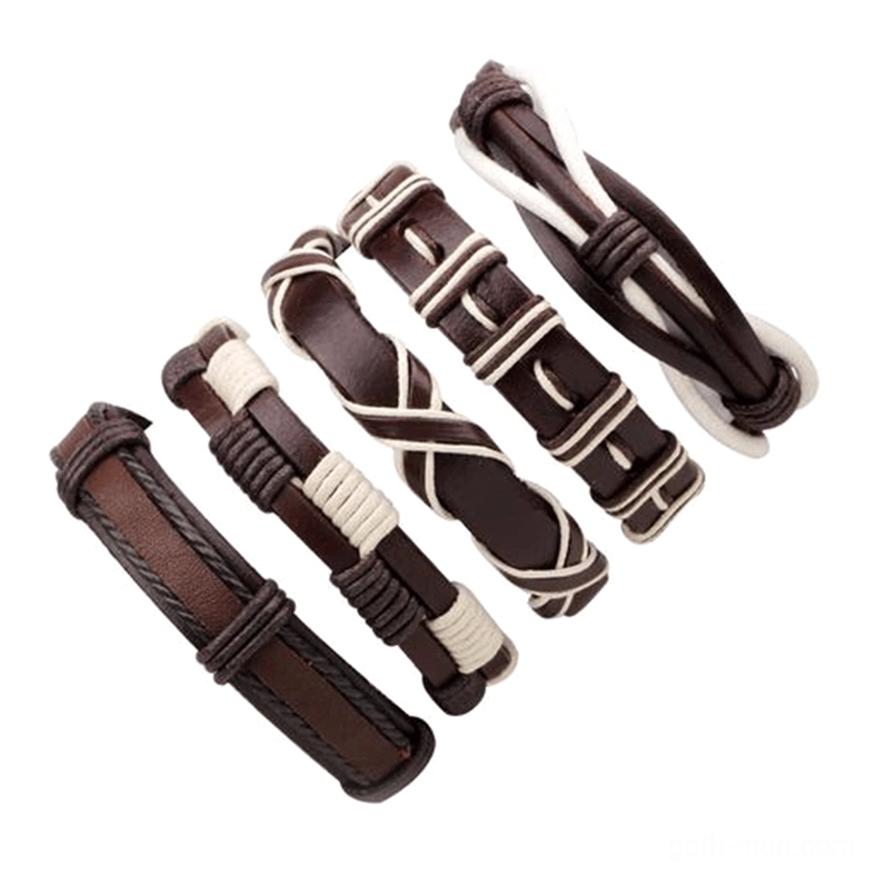 Flat lay display of five gothic leather wristbands in brown and white tones, showcasing varied braided weave designs and rock aesthetic styles